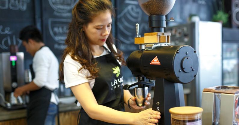Coffee Maker - Woman Grinding Coffee Bean