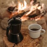 Coffee Maker - A Cup of Coffee on a Wooden Log Near the Bonfire