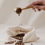 Coffee Beans - Person Holding A Scoop