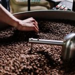 Coffee Beans - Person Holding Silver Ball on Black Round Tray